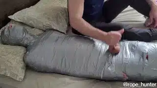 bearded dom using mummified boy as a toy