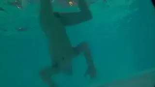 Twink loses trunks in hotel pool and swims naked