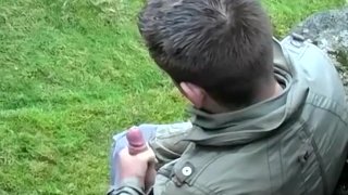 Cute twink Adam Jamieson jerks off his thick cock outdoor