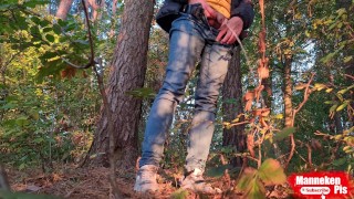 Guy long pissing in the forest under a tree